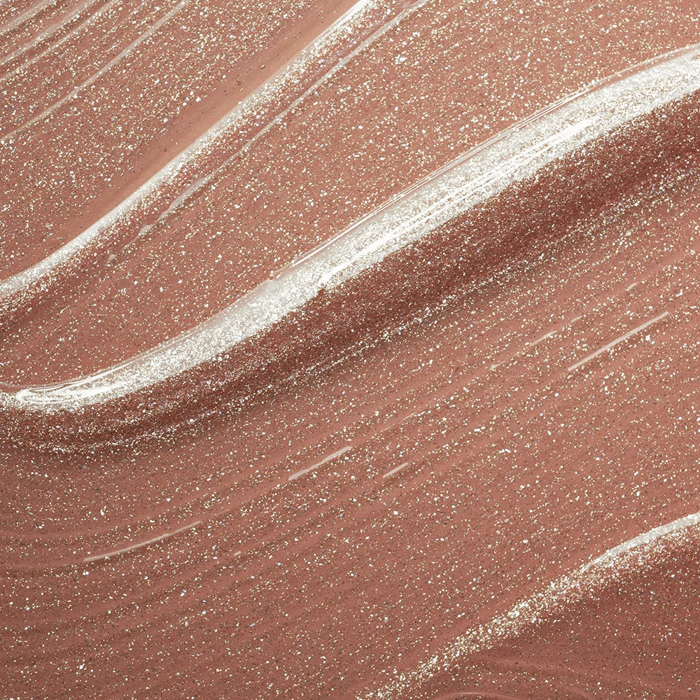 Close-up da textura cremosa e partículas douradas do gloss
