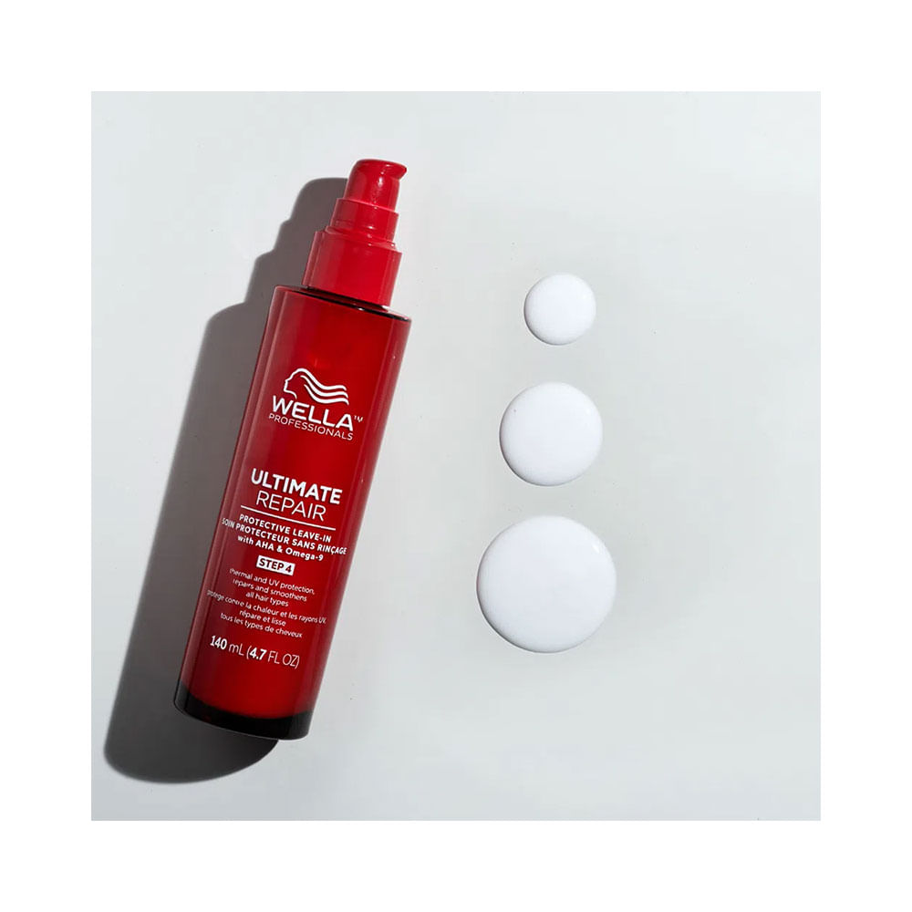 Frasco vermelho do Protetor Térmico Leave-In Wella Ultimate Repair com gotas do produto