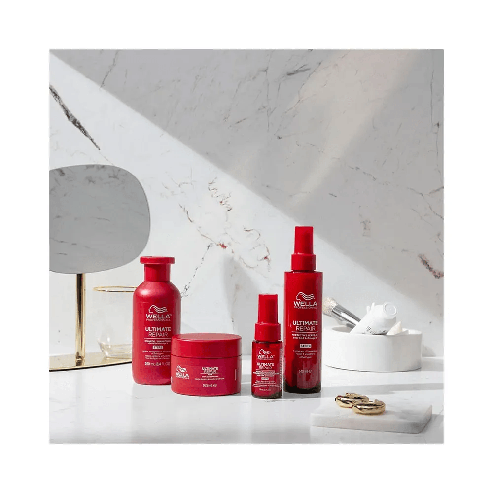 Kit Wella Ultimate Repair com shampoo, máscara e leave-in disposto em bancada branca