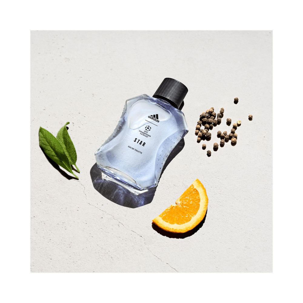 Frasco do perfume Adidas UEFA Star acompanhado de ingredientes que sugerem notas da fragrância