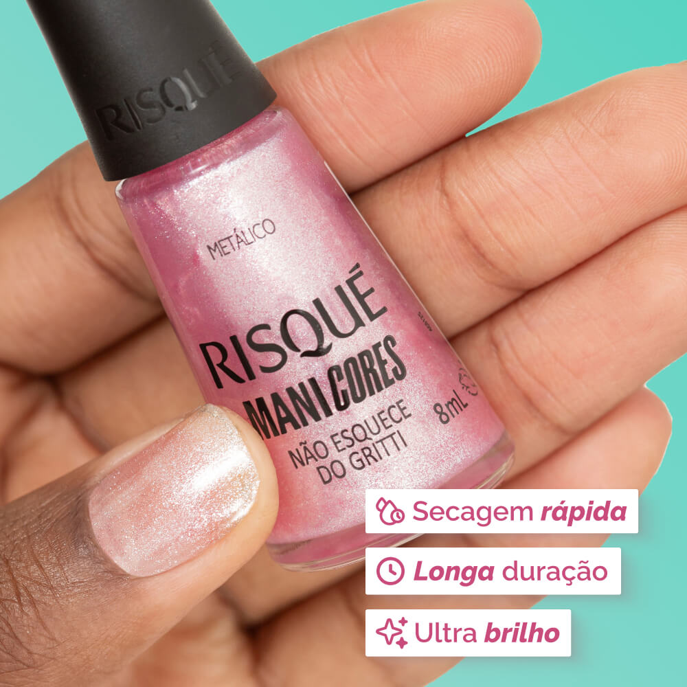 Close da mão segurando o esmalte ManiCores com unha pintada em rosa metálico