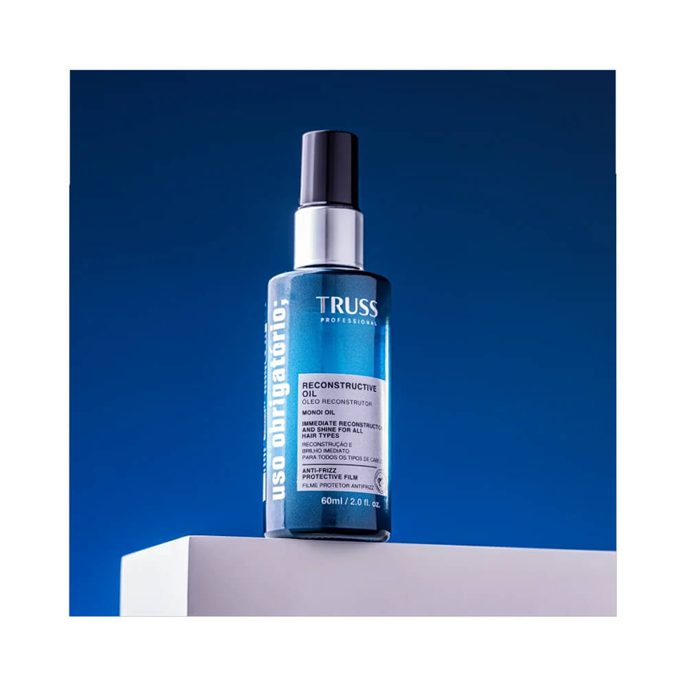 Frasco do Óleo Capilar Truss 60ml em pedestal com fundo degradê azul
