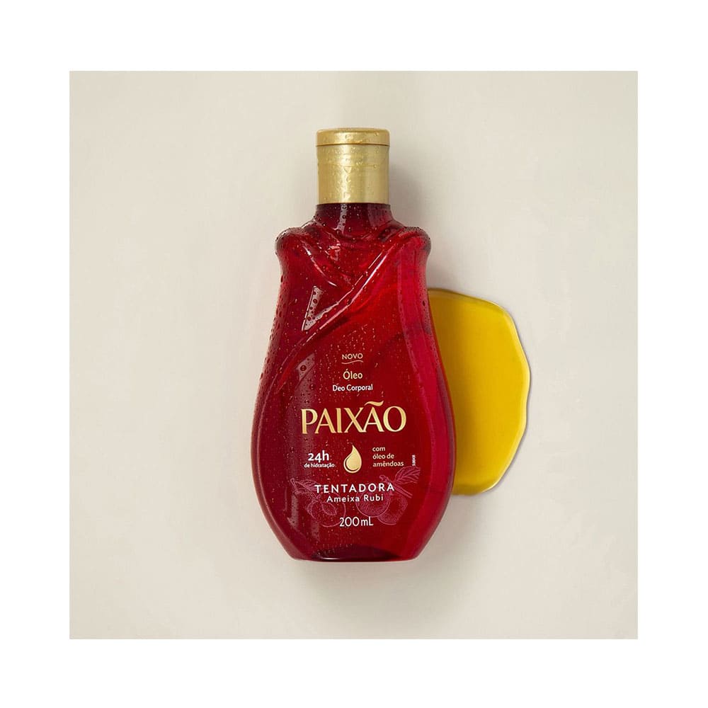 Frasco do óleo com respingo do produto e gotas d'água