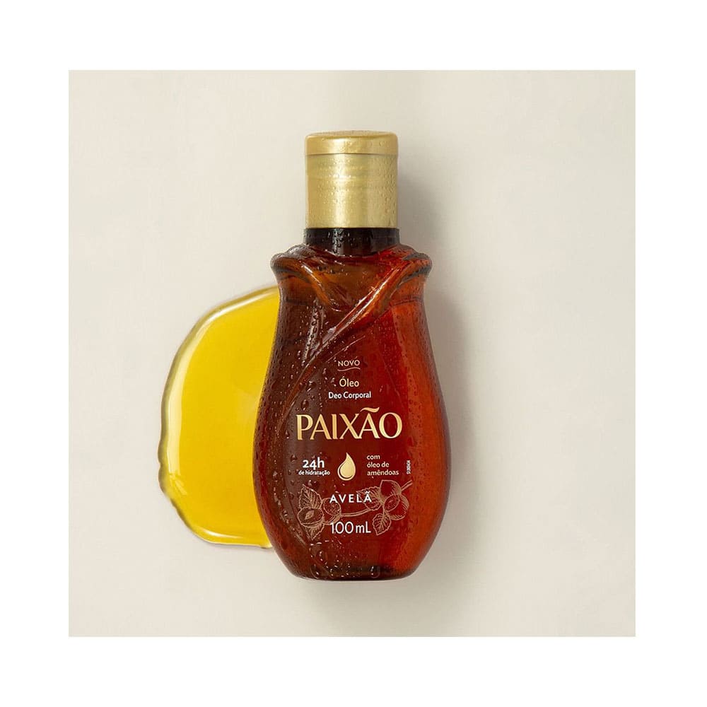 Frasco âmbar do óleo corporal Paixão ao lado de gota do produto