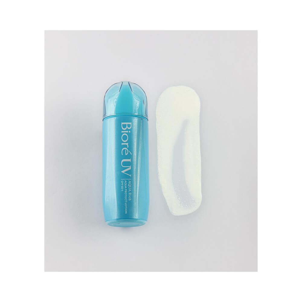 Protetor solar Bioré UV Aqua Rich Protect Lotion com textura leitosa e cremosa em destaque ao lado da embalagem azul clara.