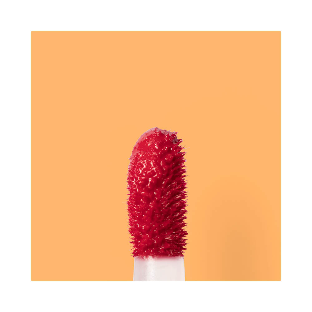 Macro do aplicador do Gloss Tint Melu com produto vermelho