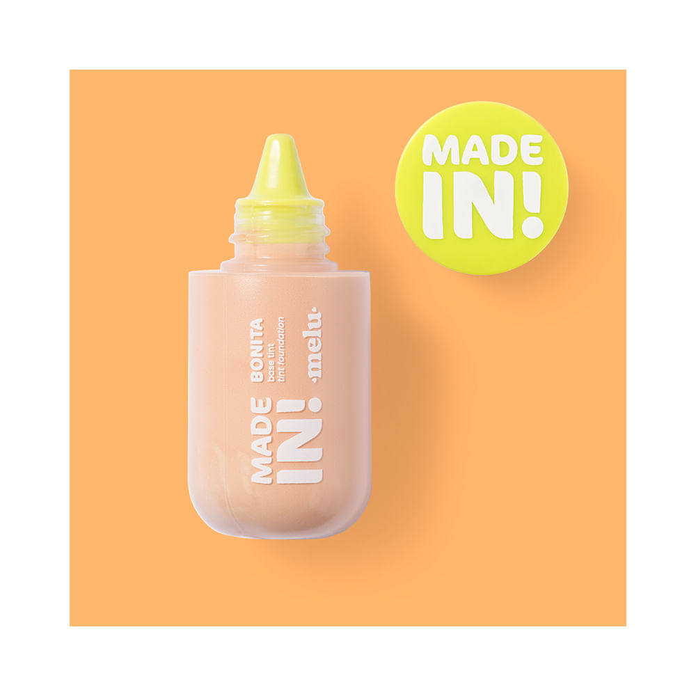 Frasco aberto da Base Melu Made In! Foundation Tint 40 com aplicador visível.