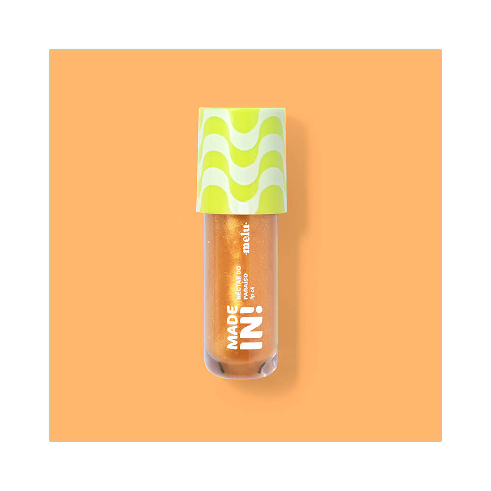 Lip Oil Melu Made In! Néctar do Paraíso em frasco transparente com óleo dourado cintilante e tampa amarela.