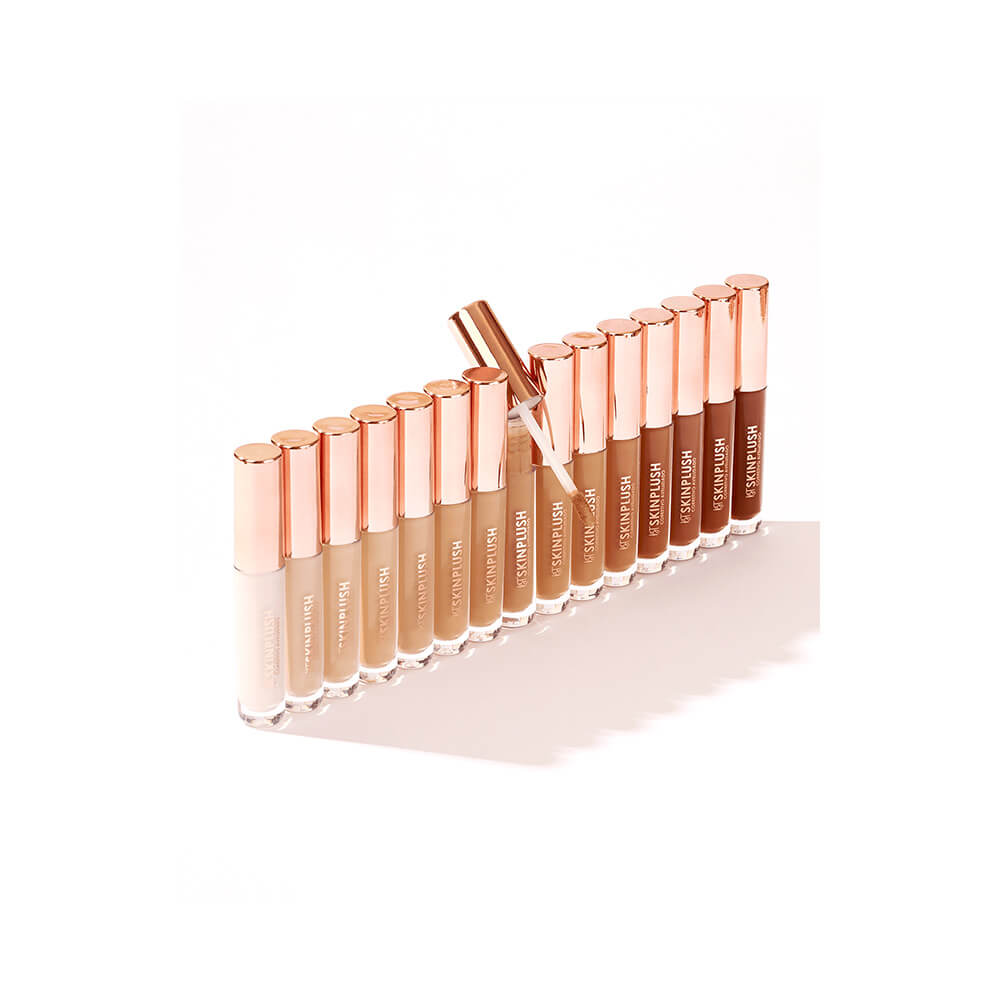 Diversas tonalidades do corretivo Bruna Tavares Skinplush em frascos transparentes com tampa rosé gold