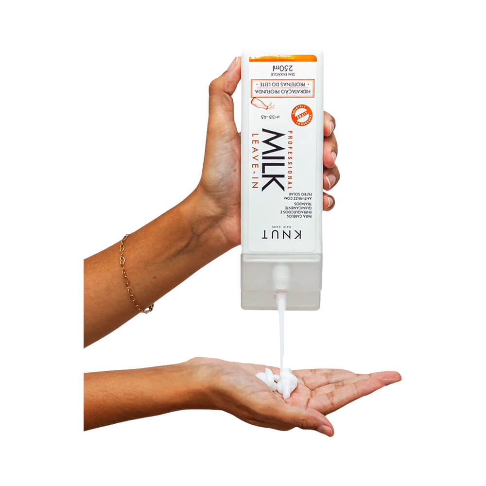 Demonstração da textura cremosa branca do Leave-In Knut Milk sendo aplicada na palma da mão