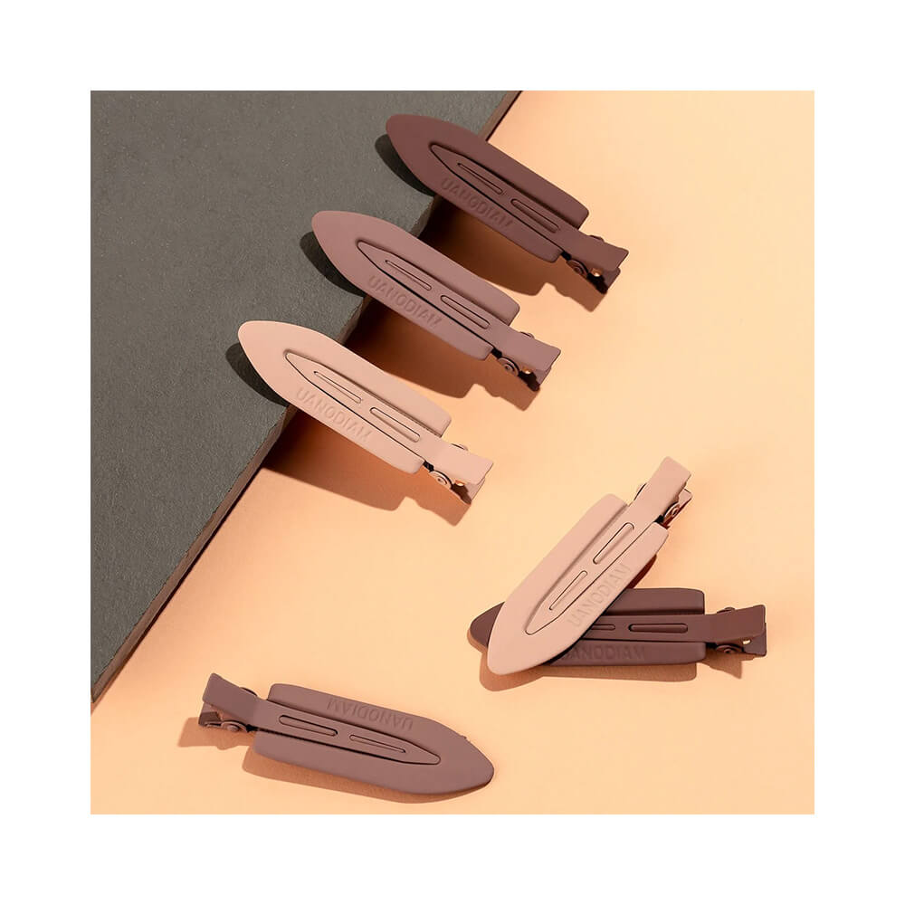 Presilhas Proart Anti Marcas em tons neutros variados sobre fundo cinza escuro e bege claro