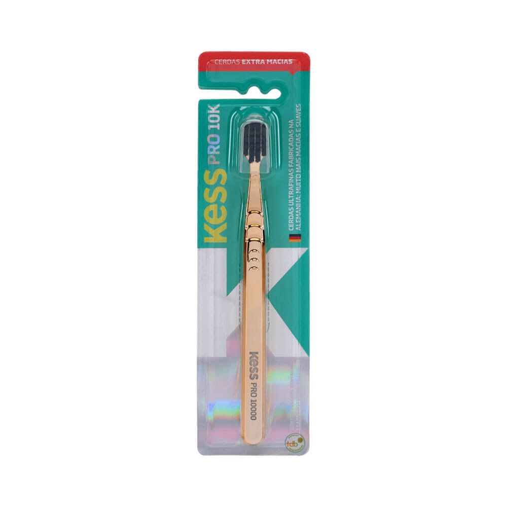 Escova Dental Kess Pro 10k Extra Macia Metallic Gold em embalagem plástica transparente com fundo verde e detalhes holográficos