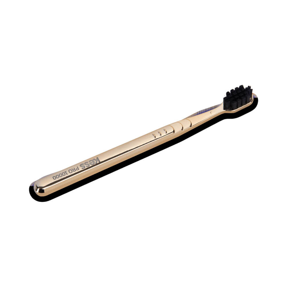 Escova Dental Kess Pro 10k Extra Macia Metallic Gold vista em ângulo lateral com cabo dourado metálico e cerdas pretas
