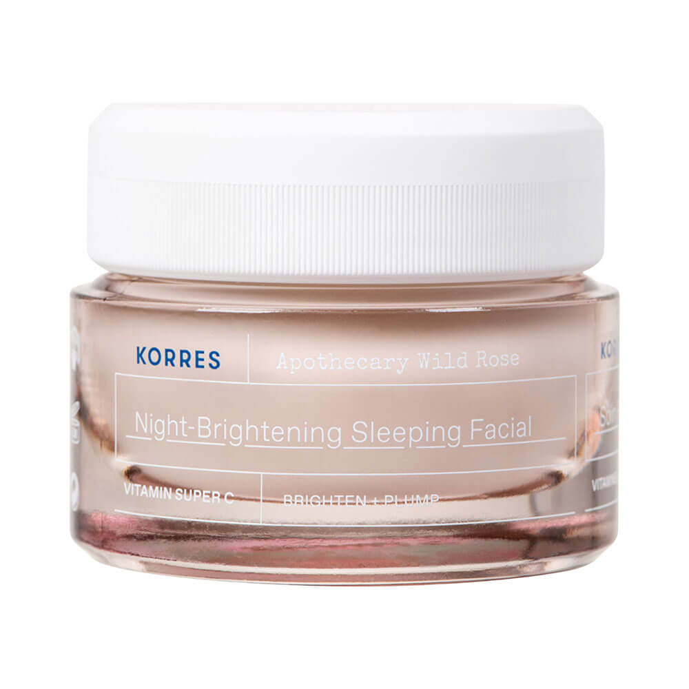 Pote de creme facial Korres Apothecary Wild Rose Clareador Noturno 40ml com tampa branca e corpo de vidro transparente mostrando o creme rosado.