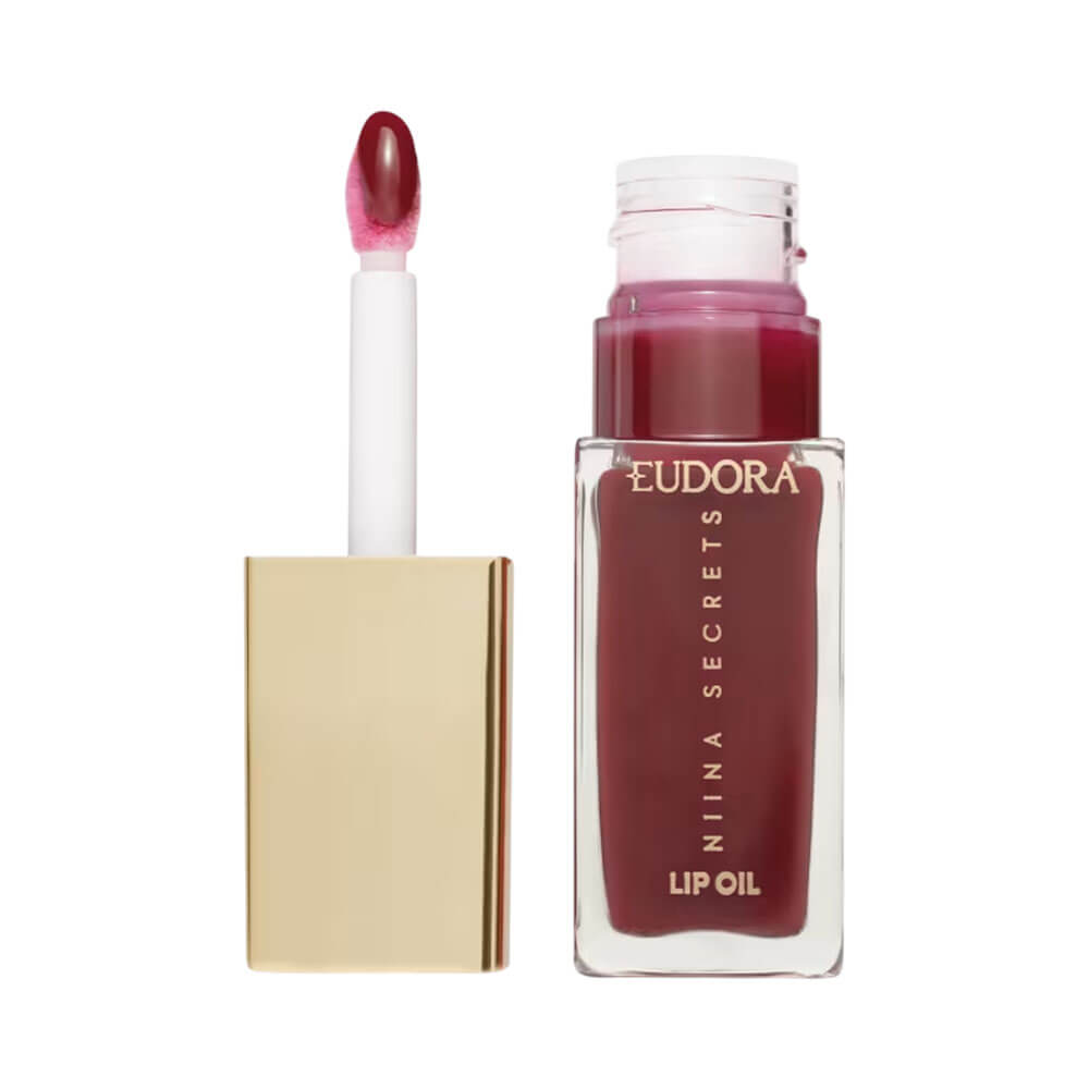 Lip Oil Niina Secrets Shine Flowers Rosa Eterna em embalagem transparente com tampa dourada, mostrando textura brilhante.