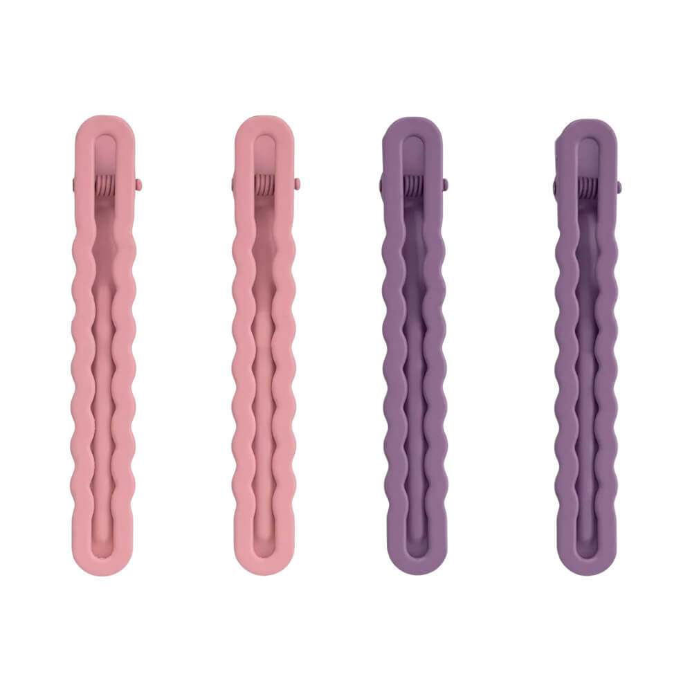 Quatro presilhas pequenas Proart Wave Color em tons rosa e lilás, com design ondulado e acabamento fosco