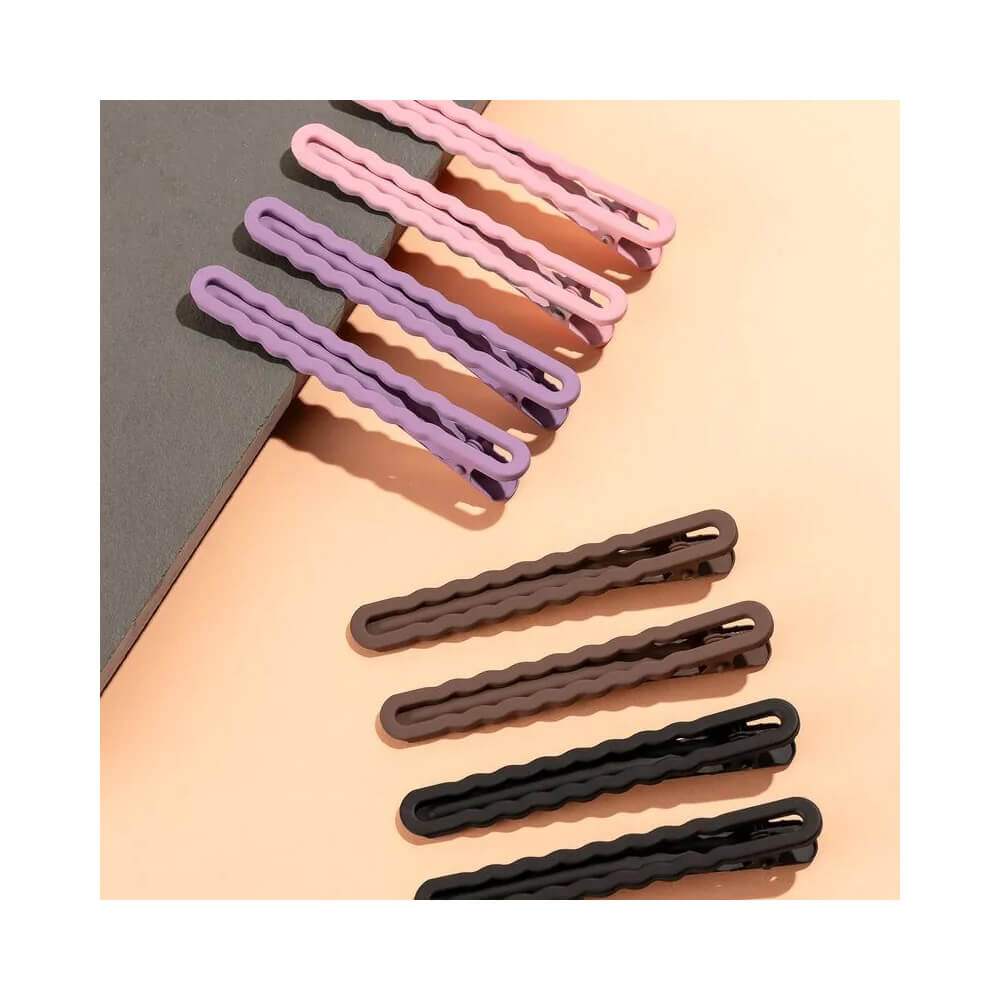 Presilhas Proart Wave Color em diversas cores dispostas sobre fundo bege, mostrando variedade e design