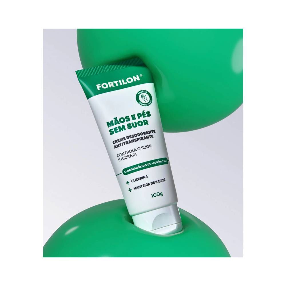 Creme Hidratante Dailus Fortilon Mãos e Pés 120g inclinado sobre bolas verdes