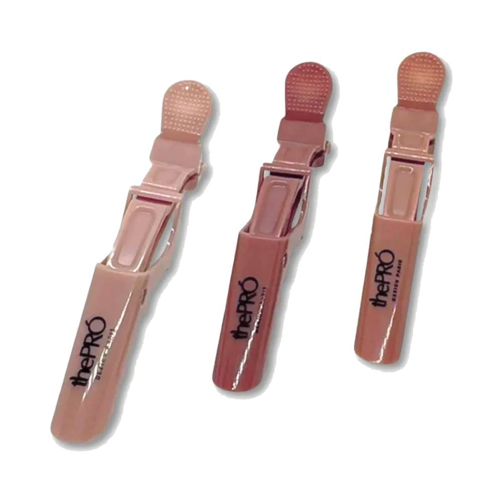 Três Clips de Cabelo The Pro Crocodilo Nude alinhados em fundo branco