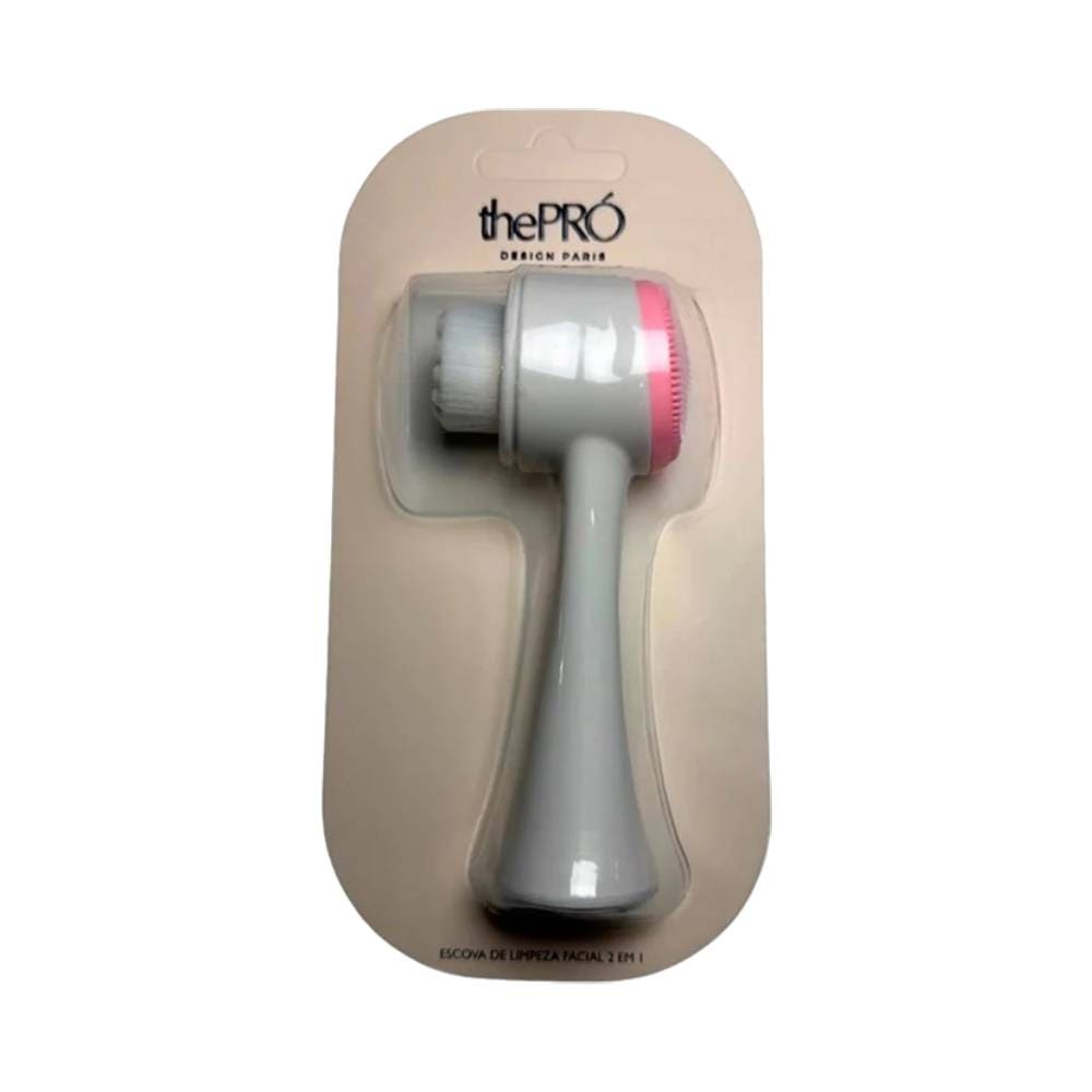 Escova de Limpeza Facial The Pro 2 em 1 cinza com detalhes rosa em embalagem transparente.